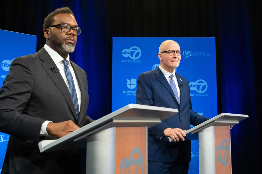 Cook County Commissioner Brandon Johnson (left) and former CPS CEO Paul Vallas (right) prepare for the mayoral debate in ABC Channel 7's WLS-TV studio on Thursday.